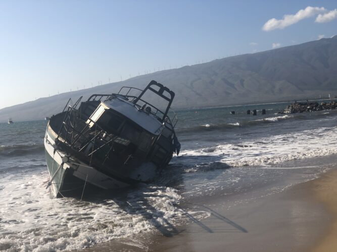A group of people pulled the grounded sailing vessel Na Hiku out of the surf in Kihei close to noon Friday.  The first attempt resulted in a tow belt breaking, 